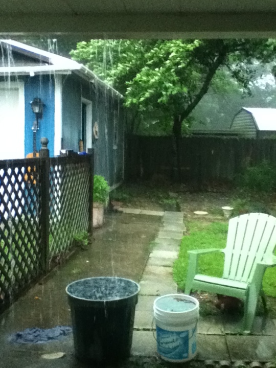Rain falling into buckets on my back porch